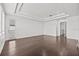 Living room featuring wood floors, recessed lighting and tray ceiling at 28565 Picana Ln, Wesley Chapel, FL 33543