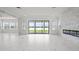 Bright living room showcasing large windows and a stunning view of the lake beyond at 28565 Picana Ln, Wesley Chapel, FL 33543