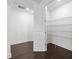 Pantry with white walls, wooden floors and metal shelving at 28565 Picana Ln, Wesley Chapel, FL 33543