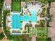 Top-down shot of the community pool featuring a lap pool, water slide, and cozy lounge areas at 28565 Picana Ln, Wesley Chapel, FL 33543