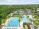 Aerial photo of the community pool area offering a lap pool, waterslide, tables, and ample seating at 28565 Picana Ln, Wesley Chapel, FL 33543