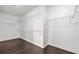 Clean and bright walk-in closet featuring wood floors and ample shelving for optimal organization and storage at 28565 Picana Ln, Wesley Chapel, FL 33543
