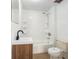 Tiled bathroom featuring a shower-tub combo, modern sink, and classic toilet at 3008 E Wilder Ave, Tampa, FL 33610