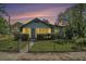 Charming bungalow featuring a cozy enclosed porch and well-maintained front yard at 3008 E Wilder Ave, Tampa, FL 33610