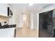 Kitchen featuring white cabinets, modern appliances, and access to laundry room at 3008 E Wilder Ave, Tampa, FL 33610