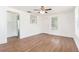 Inviting living room showcasing wood floors, a ceiling fan, and ample natural light at 3008 E Wilder Ave, Tampa, FL 33610