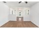 Open living room boasting wood flooring, a ceiling fan, and natural light at 3008 E Wilder Ave, Tampa, FL 33610
