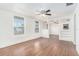 Bright living room featuring hardwood floors, a ceiling fan, and open access to other rooms at 3008 E Wilder Ave, Tampa, FL 33610