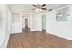 Open-concept living room with wood floors, ceiling fan, and an open view to the kitchen at 3008 E Wilder Ave, Tampa, FL 33610