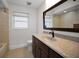 Bathroom with a granite countertop, wood cabinets, and tile floors at 3089 Ashland Ter, Clearwater, FL 33761