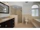 Bathroom featuring tiled floors, granite counters, walk-in shower, and garden tub at 3089 Ashland Ter, Clearwater, FL 33761