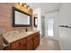 Bathroom with granite countertop, walk-in shower, and access to backyard at 3089 Ashland Ter, Clearwater, FL 33761