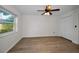 Bedroom with luxury vinyl flooring, a ceiling fan, and a double-door closet at 3089 Ashland Ter, Clearwater, FL 33761