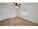 Bedroom with luxury vinyl flooring, a ceiling fan, and double-door closet at 3089 Ashland Ter, Clearwater, FL 33761