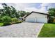 Spacious driveway leading to a well-maintained home with a two-car garage and manicured landscaping at 3089 Ashland Ter, Clearwater, FL 33761