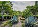 Community entrance with lush landscaping, stone accents, and established signage at 3089 Ashland Ter, Clearwater, FL 33761