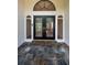 Beautiful front door with glass panels, sidelights, and a stone walkway, creating an inviting entrance at 3089 Ashland Ter, Clearwater, FL 33761