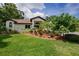 Inviting front yard featuring lush landscaping, a green lawn, and an attractive home exterior at 3089 Ashland Ter, Clearwater, FL 33761