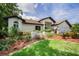 Attractive home exterior featuring lush landscaping, a well-manicured lawn, and a neutral color scheme at 3089 Ashland Ter, Clearwater, FL 33761