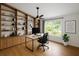 Bright home office with custom built-ins, hardwood floors, and a large window overlooking the yard at 3089 Ashland Ter, Clearwater, FL 33761