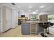 Well-equipped kitchen features a large island with bar seating, a wine fridge, and granite counters at 3089 Ashland Ter, Clearwater, FL 33761