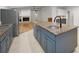 Kitchen island features granite countertops, custom cabinetry, and a stainless steel refrigerator at 3089 Ashland Ter, Clearwater, FL 33761