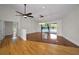 Open-concept living room with hardwood floors and sliding glass doors leading to the pool area at 3089 Ashland Ter, Clearwater, FL 33761