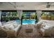 Inviting covered patio overlooking a screened pool, featuring comfortable seating and stylish decor at 3089 Ashland Ter, Clearwater, FL 33761