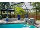 Close up of the stone pool waterfall and gazebo and views of the pool and covered lanai at 3089 Ashland Ter, Clearwater, FL 33761