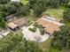 Aerial view of a large estate with multiple buildings surrounded by mature trees and green space at 309 Hidden Lake Dr, Brandon, FL 33511