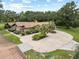 Aerial view of a sprawling home with a circular driveway and lush landscaping, showing a grand estate at 309 Hidden Lake Dr, Brandon, FL 33511