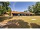 Expansive backyard featuring a screened-in porch with solar panels, perfect for outdoor living at 309 Hidden Lake Dr, Brandon, FL 33511