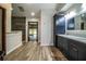 Bathroom featuring dual vanities and tile floors leading to the shower room and spa area with pool views at 309 Hidden Lake Dr, Brandon, FL 33511