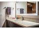 Bathroom with a vanity, a white sink, a granite countertop, a mirror, and brown cabinets at 309 Hidden Lake Dr, Brandon, FL 33511