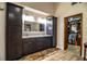 Well-appointed bathroom featuring dual vanities, dark wood cabinetry, tile flooring and adjacent walk-in closet for organized storage at 309 Hidden Lake Dr, Brandon, FL 33511