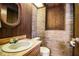 Unique bathroom features brick accent wall, wood paneling, and an oval sink with a wood countertop at 309 Hidden Lake Dr, Brandon, FL 33511