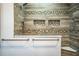 Stylish bathroom featuring decorative wood-look tile with hexagon accents, two niches, and a built-in corner seat at 309 Hidden Lake Dr, Brandon, FL 33511