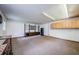 Large bonus room features carpeted floors, bright lighting, and built in shelving and cabinets at 309 Hidden Lake Dr, Brandon, FL 33511