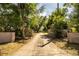 Long driveway leading to the property, lined with trees and brick features at 309 Hidden Lake Dr, Brandon, FL 33511