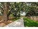 Long driveway lined with brick walls, green lawn, and shade trees, enhance the home's curb appeal at 309 Hidden Lake Dr, Brandon, FL 33511