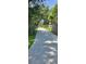 Gated driveway entrance with secure access to the property surrounded by lush trees at 309 Hidden Lake Dr, Brandon, FL 33511