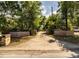 Long paved driveway leading to an estate home, lined with mature trees and brick pillars at 309 Hidden Lake Dr, Brandon, FL 33511