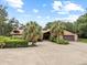 Lovely brick home with a two-car garage and expansive driveway lined with lush landscaping at 309 Hidden Lake Dr, Brandon, FL 33511