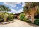 Charming brick home features a spacious driveway and lush landscaping with palm trees at 309 Hidden Lake Dr, Brandon, FL 33511