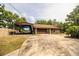 Garage with driveway and covered RV parking, plus vintage style gas pump on property at 309 Hidden Lake Dr, Brandon, FL 33511