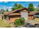 Large garage with roll up door, storage space, and additional parking area at 309 Hidden Lake Dr, Brandon, FL 33511