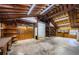 Spacious garage interior with exposed wood rafters, ample storage and a roll-up door at 309 Hidden Lake Dr, Brandon, FL 33511