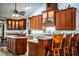 Spacious kitchen has wooden cabinets, center island, countertop seating, and stainless steel appliances at 309 Hidden Lake Dr, Brandon, FL 33511