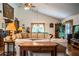 Inviting living room with vaulted ceilings, a cozy sectional sofa and a well-lit pool table in the background at 309 Hidden Lake Dr, Brandon, FL 33511