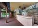 Exterior wet bar with refrigerator, brick accents, and access to a covered patio area at 309 Hidden Lake Dr, Brandon, FL 33511